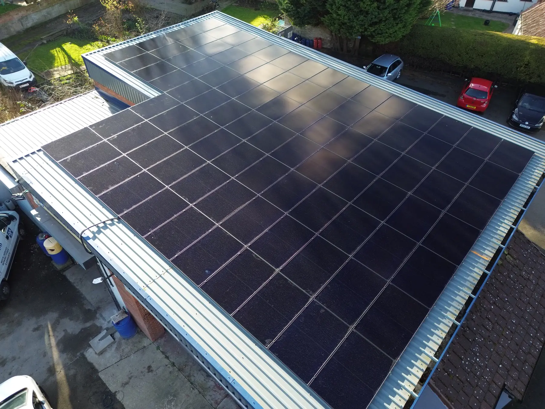 A large commercial flat roof covered with a solar array, seen from above